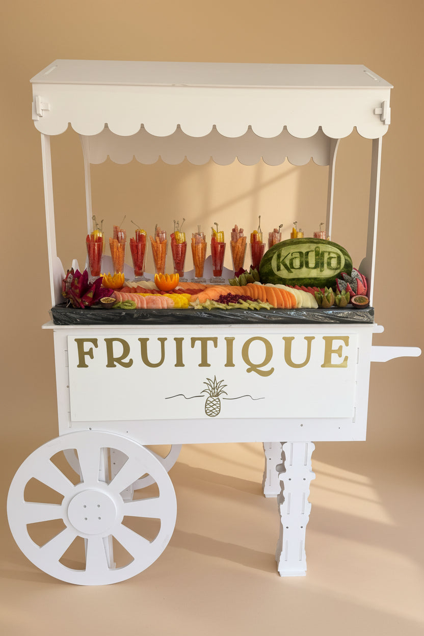 White fruit cart with 'Fruitique' branding on a beige background