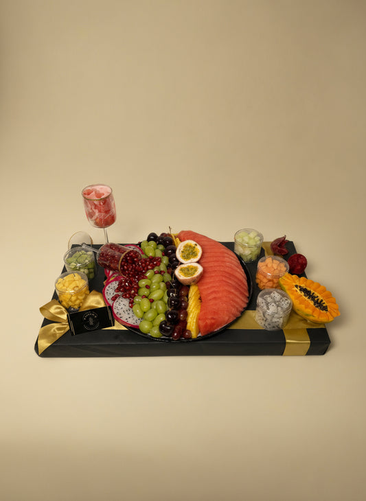 Decorative wall art resembling a fruit platter with a black frame on a white background