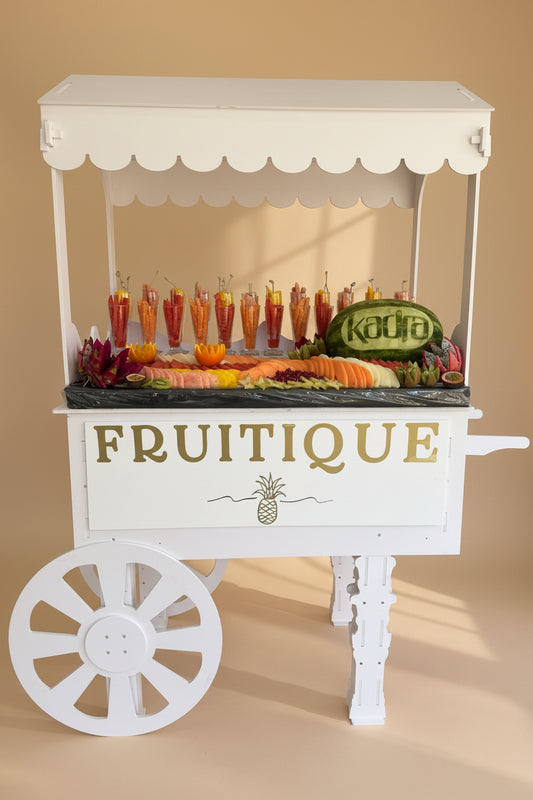 White fruit cart with 'Fruitique' branding on a beige background