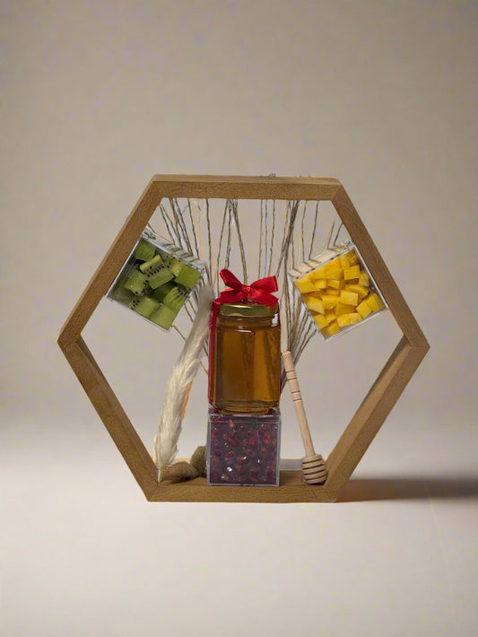 Hexagonal wooden display with a jar of honey, a honey dipper, and decorative items on a white background